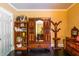 Bedroom showing a closet with mirror, dark hardwood floors, and mustard colored walls at 414 Pensdale Rd, Decatur, GA 30030