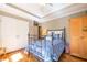 Bedroom with tray ceilings, white closet doors, hardwood floors, and ample space at 414 Pensdale Rd, Decatur, GA 30030