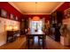 Elegant dining room featuring a large wooden table, bright red walls and unique decor at 414 Pensdale Rd, Decatur, GA 30030