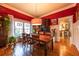 Elegant dining room featuring a large wooden table, bright red walls and unique decor at 414 Pensdale Rd, Decatur, GA 30030