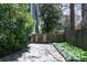 Long driveway featuring privacy gate, bordered by mature landscaping and leading to main house at 414 Pensdale Rd, Decatur, GA 30030