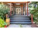 View of the front entrance leading to a screened porch, complemented by lush greenery at 414 Pensdale Rd, Decatur, GA 30030