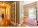 Inviting hallway showcasing hardwood floors, neutral paint, and open doorway to backyard at 414 Pensdale Rd, Decatur, GA 30030