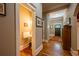 Hallway with hardwood floors leads to powder room and front door at 414 Pensdale Rd, Decatur, GA 30030