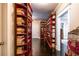Hallway lined with floor to ceiling bookshelves and dark hardwood floors at 414 Pensdale Rd, Decatur, GA 30030