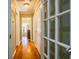 Hallway with hardwood floors leading to living areas with multiple doorways to other rooms at 414 Pensdale Rd, Decatur, GA 30030