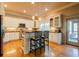 Well-lit kitchen with stainless steel appliances, a breakfast bar, and hardwood flooring at 414 Pensdale Rd, Decatur, GA 30030
