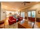 Open living room featuring a kitchen, red armchairs, hardwood floors and access to the outdoors at 414 Pensdale Rd, Decatur, GA 30030