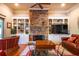 Cozy living room with a stone fireplace, built-in shelving, and comfortable seating at 414 Pensdale Rd, Decatur, GA 30030