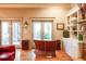 Bright living room with a custom bar, built-in shelves, and glass doors leading to the outdoor space at 414 Pensdale Rd, Decatur, GA 30030