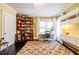 Office space with a large bookshelf, desk, rolling office chair and black hardwood floors at 414 Pensdale Rd, Decatur, GA 30030