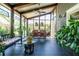 Enclosed porch featuring comfortable seating, dining area, and lush greenery at 414 Pensdale Rd, Decatur, GA 30030