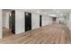 Spacious finished basement features sleek flooring, recessed lights, and modern black doors at 4366 Skyland Ne Dr, Atlanta, GA 30342