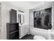Modern bathroom featuring a shower over tub with dark tile and contemporary vanity at 4366 Skyland Ne Dr, Atlanta, GA 30342