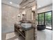 Bright bathroom featuring double vanities, sleek fixtures, statement marble wall, and a luxurious soaking tub at 4366 Skyland Ne Dr, Atlanta, GA 30342