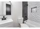 Modern bathroom features a tub with designer tile surround and dark fixtures at 4366 Skyland Ne Dr, Atlanta, GA 30342