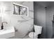 Modern bathroom features marble tile, black fixtures, a sleek vanity, and a window with natural light at 4366 Skyland Ne Dr, Atlanta, GA 30342