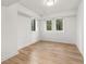 Bright bedroom with hardwood floors, two windows, and white walls at 4366 Skyland Ne Dr, Atlanta, GA 30342