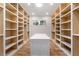 Spacious walk-in closet featuring custom shelving, storage, and a central island with white countertop at 4366 Skyland Ne Dr, Atlanta, GA 30342