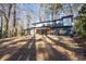 Contemporary two-story home with sleek lines, balconies, and large windows surrounded by trees at 4366 Skyland Ne Dr, Atlanta, GA 30342