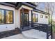 Home front entrance featuring a black door, black framed windows and black porch railing at 4366 Skyland Ne Dr, Atlanta, GA 30342