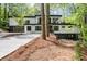 Modern two-story home with sleek lines, a concrete driveway, and a wooded lot at 4366 Skyland Ne Dr, Atlanta, GA 30342