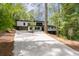 Modern home with a long driveway surrounded by mature trees at 4366 Skyland Ne Dr, Atlanta, GA 30342