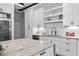 Contemporary kitchen featuring a large island, open shelving, and stainless steel appliances at 4366 Skyland Ne Dr, Atlanta, GA 30342
