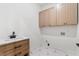 Spacious laundry room includes custom cabinets, modern fixtures, and stylish tile flooring at 4366 Skyland Ne Dr, Atlanta, GA 30342