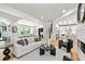 Open concept living room with hardwood floors, modern fireplace, and views to dining room at 4366 Skyland Ne Dr, Atlanta, GA 30342