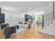 Open concept living room with hardwood floors, modern decor, stairway and dining space at 4366 Skyland Ne Dr, Atlanta, GA 30342