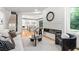 Open concept living room with hardwood floors, modern fireplace, and views to kitchen at 4366 Skyland Ne Dr, Atlanta, GA 30342