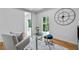 Well-lit home office with glass table, grey chairs, wood floors, modern decor, and natural light at 4366 Skyland Ne Dr, Atlanta, GA 30342