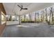 Outdoor patio features wood siding, ceiling fans, and a view of the wooded backyard at 4366 Skyland Ne Dr, Atlanta, GA 30342