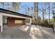 Covered patio with wood siding, black accents, and views of the surrounding trees at 4366 Skyland Ne Dr, Atlanta, GA 30342