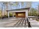 Wide angle shot of a covered patio, featuring wood siding, black accents, and trees at 4366 Skyland Ne Dr, Atlanta, GA 30342