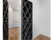 Hallway featuring a large black wine rack with view to living spaces and white cabinets at 4366 Skyland Ne Dr, Atlanta, GA 30342
