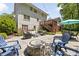 Spacious backyard featuring a stone patio with seating and access to a deck at 5040 Winding Branch Dr, Dunwoody, GA 30338