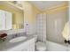 Bright bathroom with a single sink, shower-tub combination, and yellow walls at 5040 Winding Branch Dr, Dunwoody, GA 30338