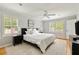 Bright bedroom with hardwood floors, ceiling fan, and white shutters at 5040 Winding Branch Dr, Dunwoody, GA 30338