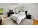 Bright bedroom with hardwood floors, ceiling fan, and white linens at 5040 Winding Branch Dr, Dunwoody, GA 30338