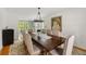Spacious dining room featuring a long table, tufted chairs, and stylish lighting at 5040 Winding Branch Dr, Dunwoody, GA 30338