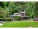 Charming community clubhouse with covered patio, lush landscaping, and playground at 5040 Winding Branch Dr, Dunwoody, GA 30338