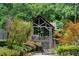 Relaxing outdoor gazebo with stone accents, surrounded by mature trees and landscaping at 5040 Winding Branch Dr, Dunwoody, GA 30338