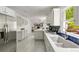 Modern kitchen with stainless steel appliances, white cabinets, and a bright window at 5040 Winding Branch Dr, Dunwoody, GA 30338