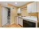 Laundry room including washer, dryer, sink, and cabinetry for storage at 5040 Winding Branch Dr, Dunwoody, GA 30338