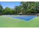 Well-maintained tennis courts with benches and surrounding greenery for an active lifestyle at 5040 Winding Branch Dr, Dunwoody, GA 30338