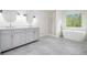 Modern bathroom featuring double vanity, soaking tub and separate walk-in shower at 881 Springs Crest Dr, Dallas, GA 30157