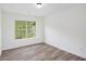 Bedroom with wood-look floors and a window overlooking the lush green trees outside at 881 Springs Crest Dr, Dallas, GA 30157
