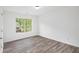 Bedroom featuring hardwood floors and a window offering outside views at 881 Springs Crest Dr, Dallas, GA 30157